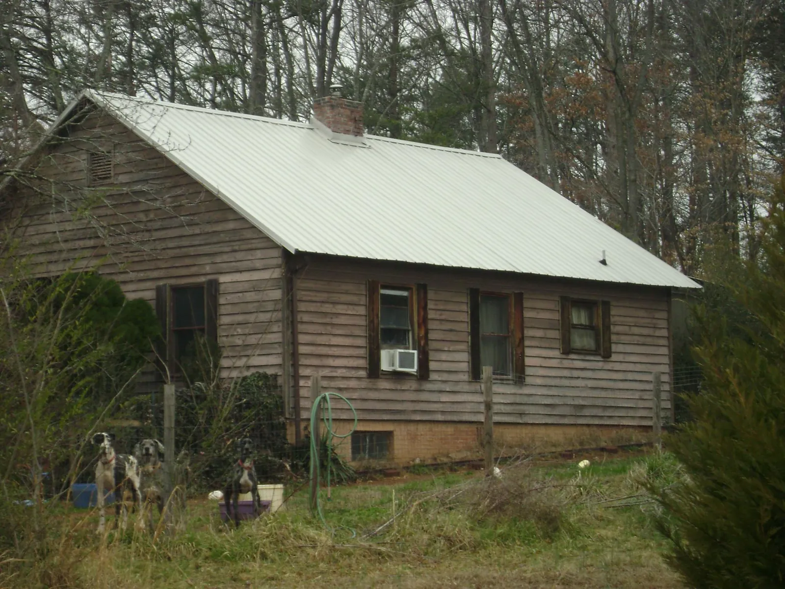 White metal roof on an old wood sided farmhouse, from a Metal Roof Installation job in Sandy Hook